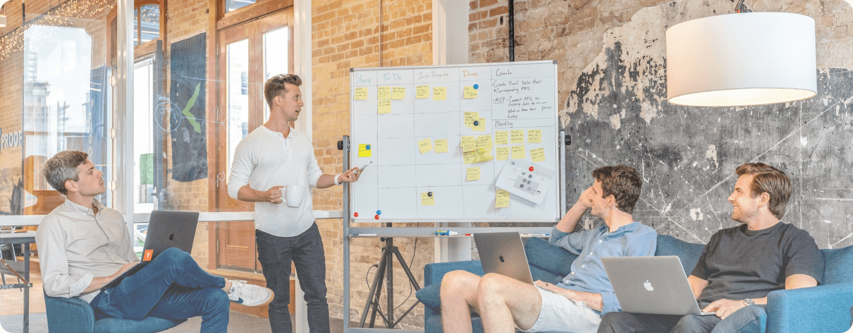 Novatore team planning work together at a whiteboard